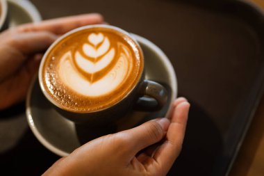 Ellerin sanatla dolu bir fincan latte.