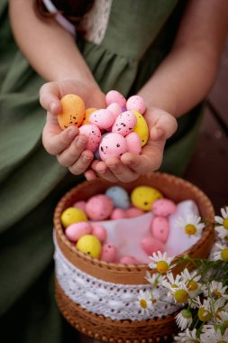 Easter basket with eggs and a bouquet of wild daisies. High quality photo clipart