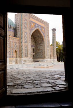 Antique oriental arch decorated with mosaics, ancient mosque in Samarkand, Uzbekistan. Historical landmarks. . High quality photo clipart