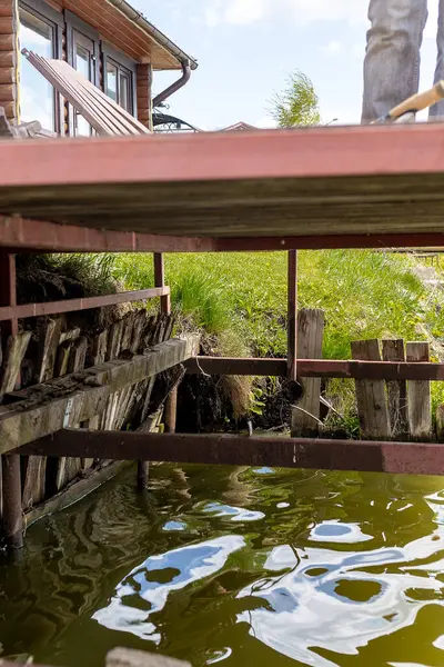 Güçlü kirişlerle desteklenen ahşap bir iskele, kıyıları yıkayan nazik dalgalar. Yüksek kalite fotoğraf