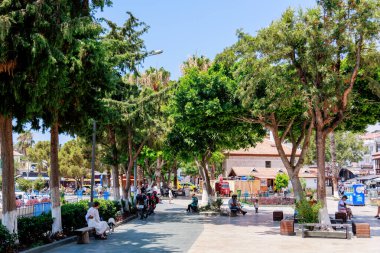 Kas, Türkiye 10 Temmuz 2025: İnsanlar marinanın yanındaki meydanda, çok sayıda kafe ve turist dükkanıyla çevrili şekilde oturuyorlar. Yüksek kalite fotoğraf