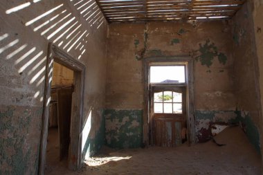 Kolmanskop, Namibya - 13 Eylül 2019: Luderitz 'in dışındaki hayalet şehir Kolmanskop' ta terk edilmiş binalar, bir zamanlar gelişen elmas madenciliği yerleşkesi, şimdi Namib Çölleri tarafından ele geçirildi.
