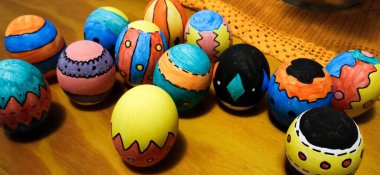 Hand painted and decorated chicken eggshells for the traditional Easter morning egg hunt. The painting has bright, vibrant colors and is designed with line patterns. clipart