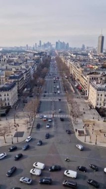 Aerial Paris cityscape with view to La Defense metropolitan district, France. Beautiful parisian architecture with historic buildings, landmarks and busy city streets with car traffic, vertical orientation