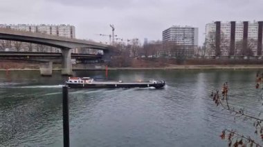 Barge cargo boat move on the Seine river, Asnieres, Paris, France