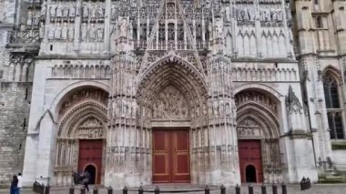 Outdoor facade view of Notre Dame de Rouen Cathedral in the Normandy, France. Architectural landmark featuring styles from Early Gothic to late Flamboyant and Renaissance architecture