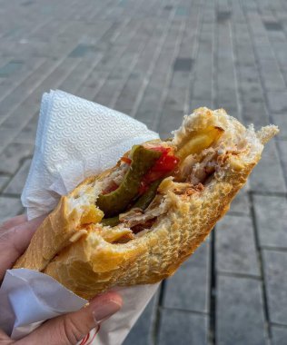 Lezzetli bir baget sandviçi, açık havada, hızlı, sıradan bir atıştırmalık olarak, büyük şehirde yoğun bir hayatta.. 
