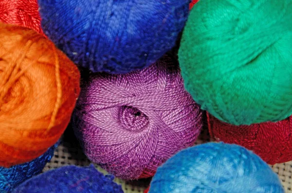 multi-colored skeins of thread, focal point in the center. skeins of thread close-up