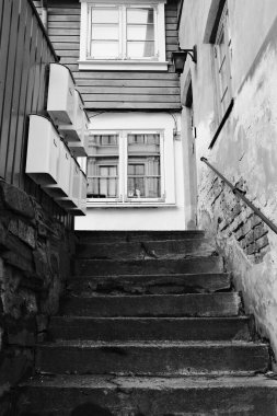 A picturesque black and white image showcasing a stone staircase leading to an inviting upper-level window adorned with mailboxes, highlighting a sense of home and community. clipart