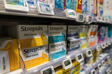 Fransa 'nın başkenti Paris' teki bir eczanenin raflarında 13 Ocak 2025 'te çeşitli Strepsils ve diğer öksürük şurubu paketleri düzenli olarak düzenlenir. Parlak renkli kutular dikkat çeker, gösteriş yaparlar.