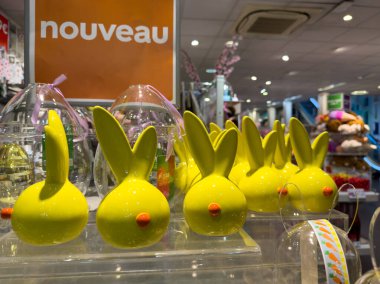 Paris,France-25.02.2025 Colorful yellow bunnies with cute features line a display in a festive store, capturing the spirit of spring celebrations and holiday cheer. clipart