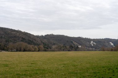 La Roche-Guyon 'daki bulutların altında uzanan yuvarlanan yeşil tarlalar bu güzel Fransız topluluğunun huzurlu cazibesini gözler önüne seriyor..