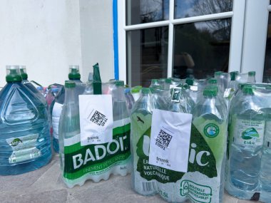 Villennes-sur-Seine, Fransa-14-03-2025 Açık hava alanında, çeşitli plastik şişeler geri dönüşüm için etiketlenmiş ve toplanmaya hazırdır,