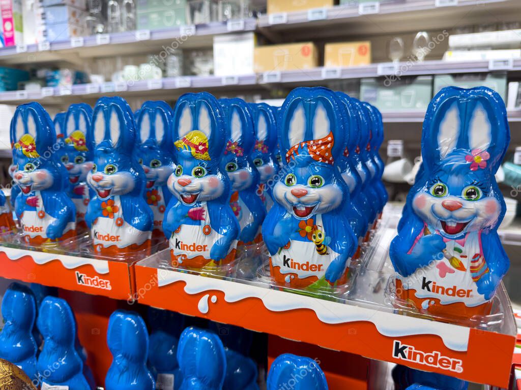 Paris,France-16-03-2025 Vibrant blue chocolate bunnies are lined neatly on shelves, each adorned with playful accessories, inviting springtime festivities and sweet treats.