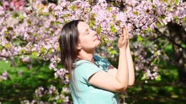 young woman in a cherry blossom garden