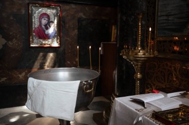 Güzel bir Ortodoks kilisesinde mum yakan vaftiz fontu, vaftiz törenine hazırlık.