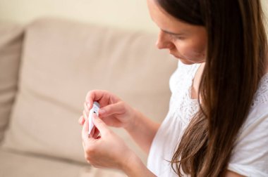 Sıcaklık, konsept, hastalık ve kendini izleme ölçerken soğuk semptomlarına sahip yorgun bir kadının yakın çekimi.