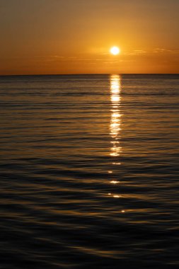 Sakin bir okyanusta gün batımı