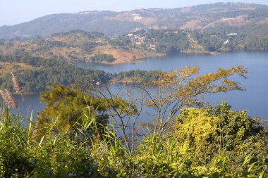 Umiam Gölü, Meghalaya 'nın yemyeşil tepelerinde huzur içinde uzanıyor. Sakin suları gökyüzünü ve etrafındaki ormanları yansıtıyor. Dağlık bölgelere yerleşmiş, sakin bir geri çekilme ve doğanın el değmemiş güzelliğinin nefes kesici bir görüntüsünü sunuyor..