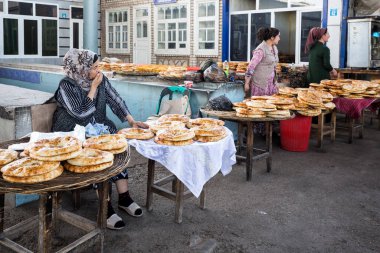 URGUT, UZBEKISTAN - APRIL 16, 2022: View of local bread sellers at Urgut's market in the Samarqand Region of Uzbekistan clipart