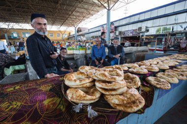 URGUT, UZBEKISTAN - APRIL 16, 2022: View of local bread sellers at Urgut's market in the Samarqand Region of Uzbekistan clipart