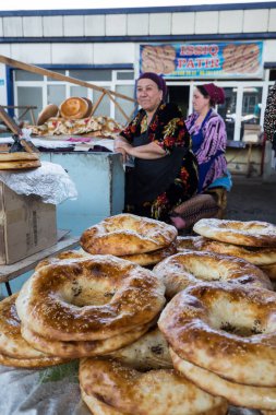 URGUT, UZBEKISTAN - APRIL 16, 2022: View of local bread sellers at Urgut's market in the Samarqand Region of Uzbekistan clipart