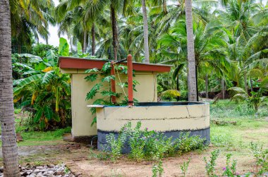 Well and a pumphouse in a farm clipart