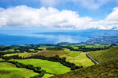 North coast of Sao Miguel Island, Azores, Acores, Portugal, Europe. Lagoa de Pau Pique in the foreground, a hidden lake in the crater of the volcano.
