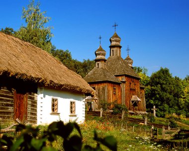 Old ukrainian house and church, Open-air museum of ukrainian architecture, Kiev, Pirogovo, Ukraine. clipart