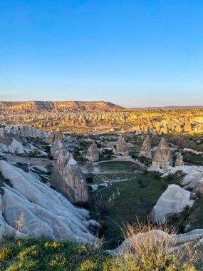 Goreme, Cappadocia 'da güzel bir günbatımında peri bacaları ve kırmızı vadi manzarası 