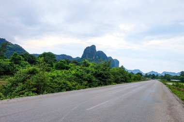 Country side roads, beautiful green nature, rice paddy and mountain in the south of Laos, Khammuane province 