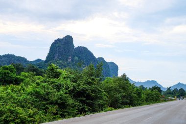 Country side roads, beautiful green nature, rice paddy and mountain in the south of Laos, Khammuane province 