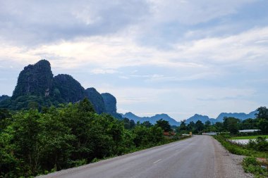 Country side roads, beautiful green nature, rice paddy and mountain in the south of Laos, Khammuane province 
