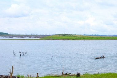Fresh green nature, local boats, fisherman at Nakai Plateau Reservoir of Namthuen 2 dam and hydropower, Laos  