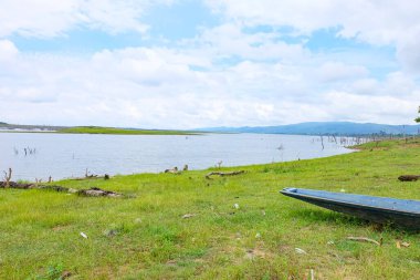Fresh green nature, local boats, fisherman at Nakai Plateau Reservoir of Namthuen 2 dam and hydropower, Laos  