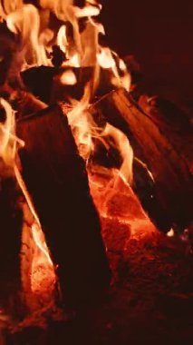 A captivating image of crackling firewood illuminated by dancing flames, perfect for warmth and comfort
