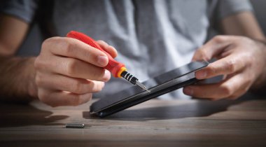 Teknisyen akıllı telefonu tamir ediyor. Onarım servisi