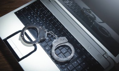 Bilgisayar klavyesinde kelepçe. Siber Suçlar