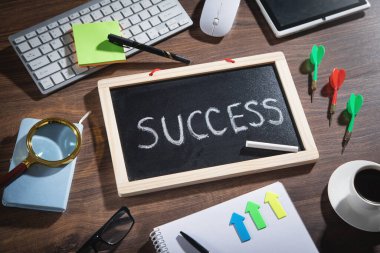 Kahve ve diğer nesneler ile tahtada başarı metni.