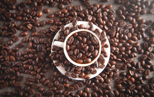 Cup of coffee on coffee beans.