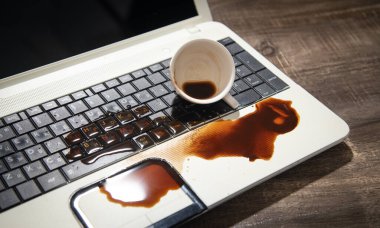 Coffee spilled over laptop keyboard clipart