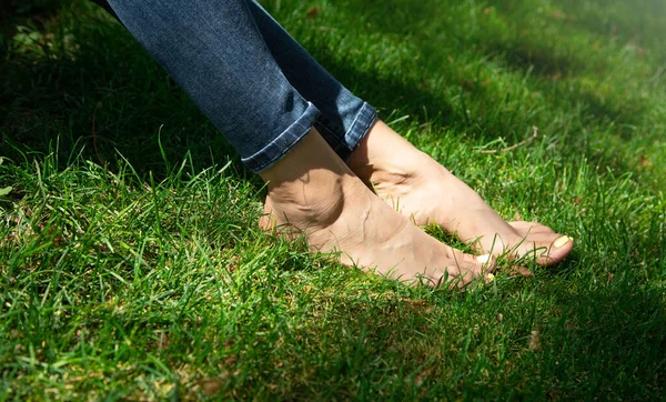 Woman legs relax feeling on green grass background.