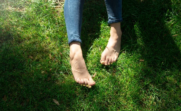 Woman legs relax feeling on green grass background.