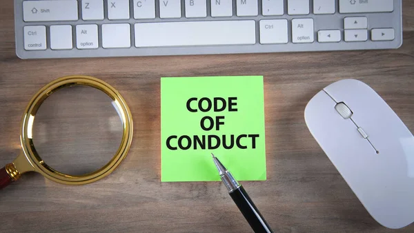 Text Code Of Conduct on sticky note.