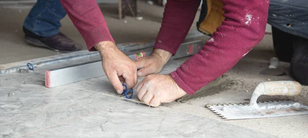Laying floor ceramic tile. Renovating the floor