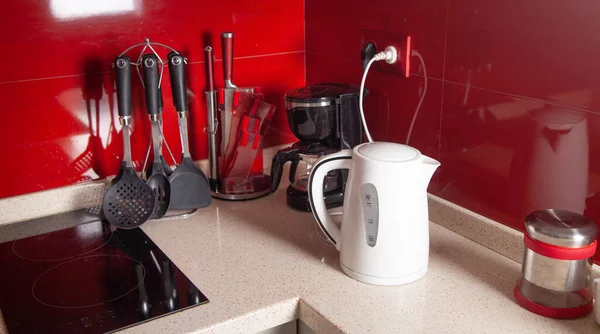 stock image Set of cookware, white kettle in kitchen.