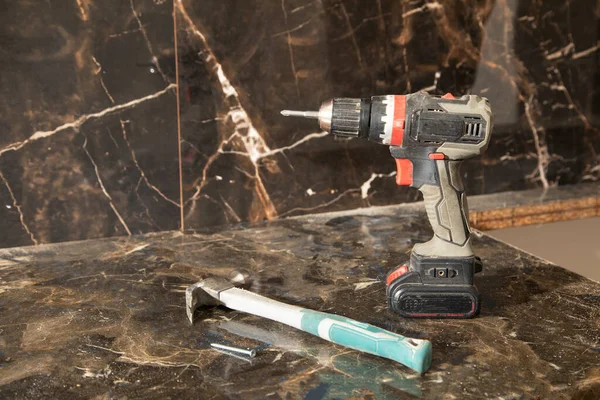 Cordless screwdriver at home. Construction tool