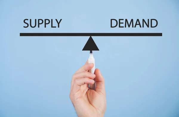 stock image Male hand draws supply and demand word balance scales. Business concept