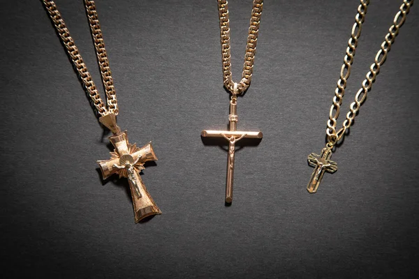 stock image Golden cross necklace on the black background.