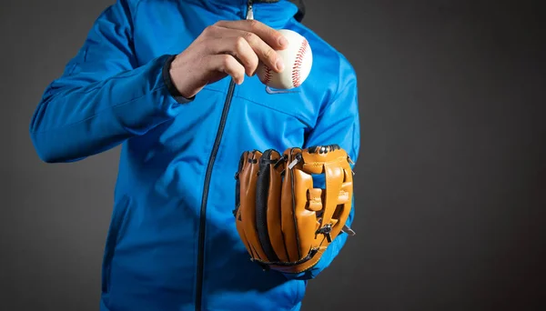 Man showing baseball ball and leather glove.